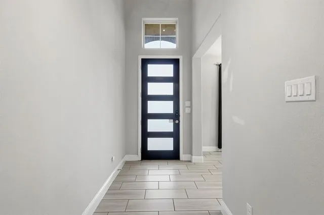a view of an entryway and an empty room
