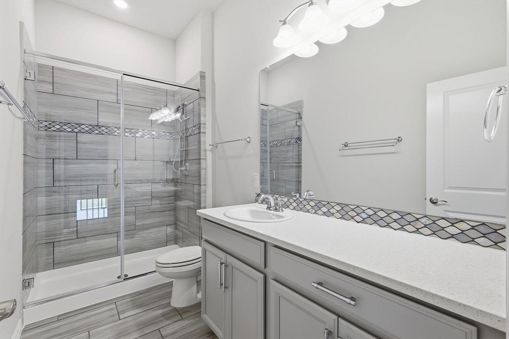 2114 Stanhill Drive Corinth, TX 76210 - Photo 33 of 40 a bathroom with a sink a toilet and shower