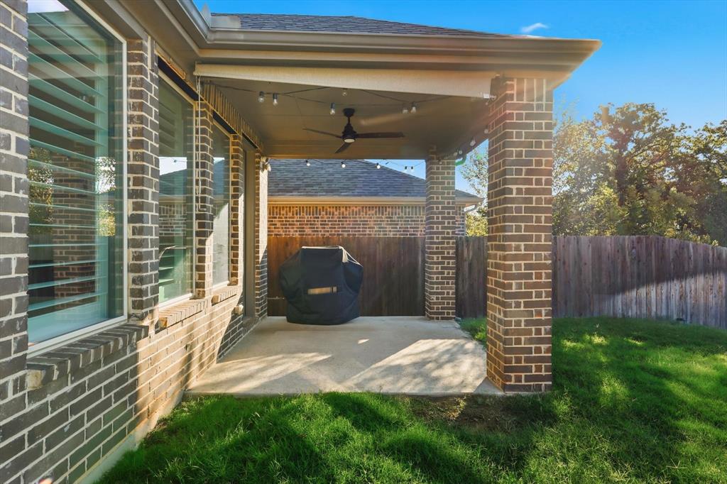 2114 Stanhill Drive Corinth, TX 76210 - Photo 35 of 40 a view of backyard with tub and wooden fence
