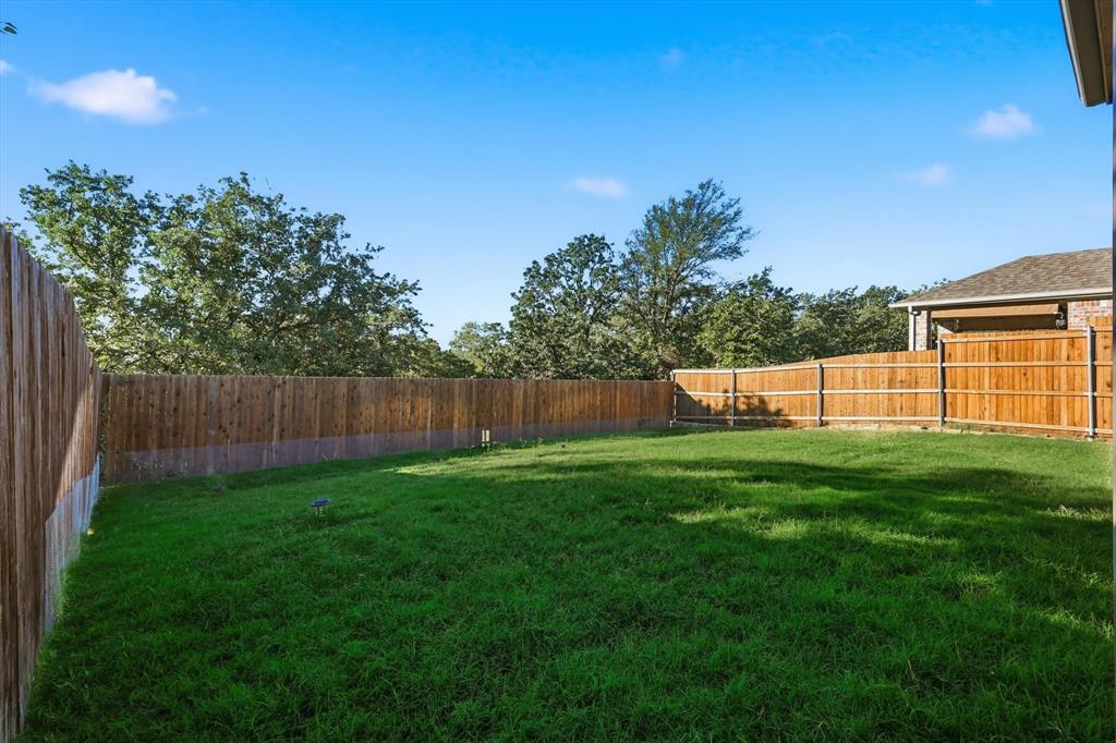 2114 Stanhill Drive Corinth, TX 76210 - Photo 36 of 40 a view of a backyard with a garden
