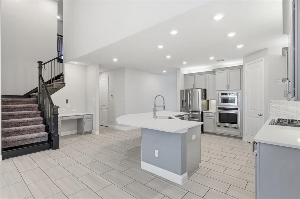 2114 Stanhill Drive Corinth, TX 76210 - Photo 6 of 40 a kitchen with refrigerator and cabinets
