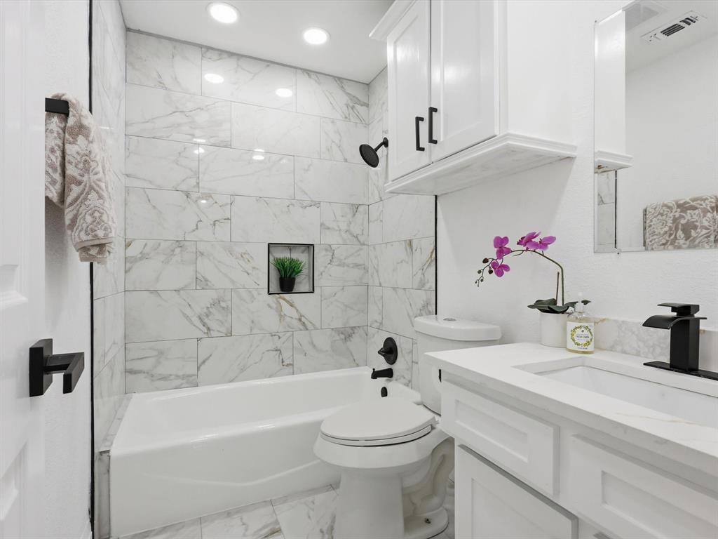 1202 High Ridge Drive Duncanville, TX 75137 - Photo 17 of 28 a bathroom with a sink a toilet and shower