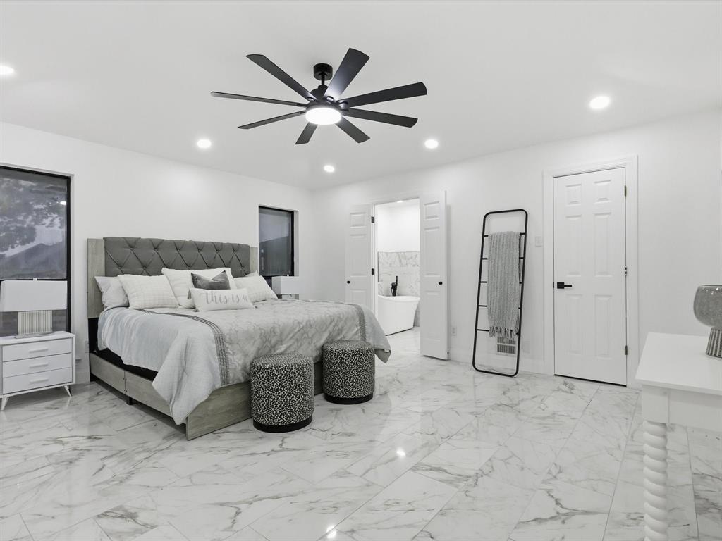 1202 High Ridge Drive Duncanville, TX 75137 - Photo 19 of 28 a bedroom with a bed a ceiling fan and a rug