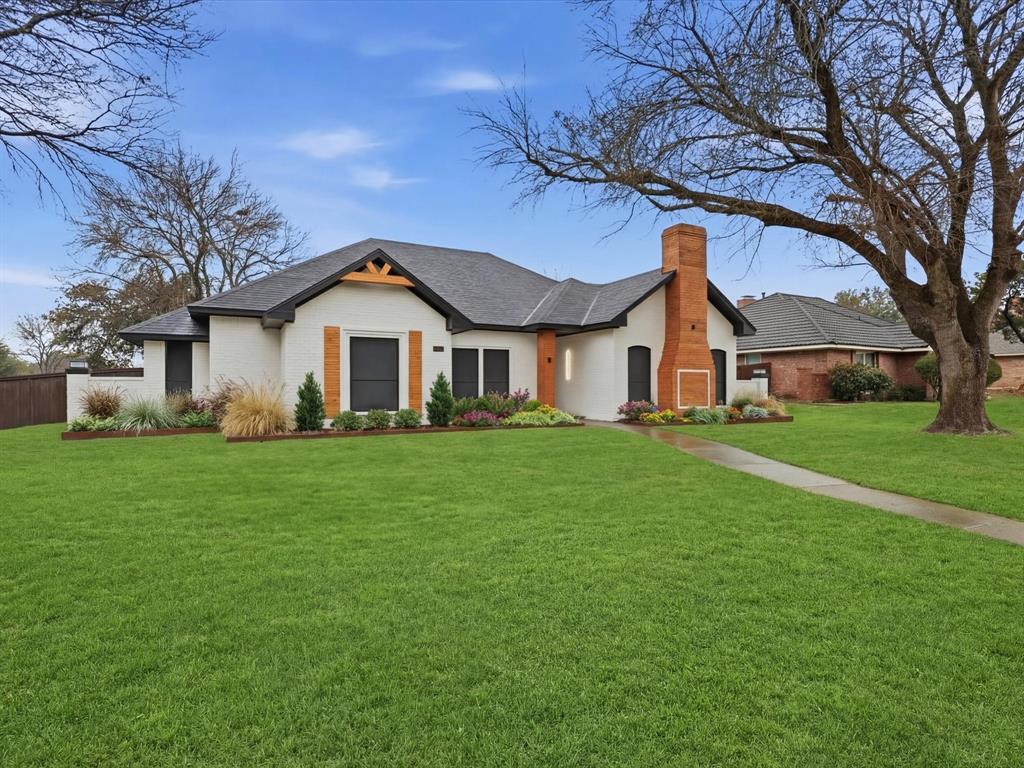 1202 High Ridge Drive Duncanville, TX 75137 - Photo 2 of 28 a front view of a house with a garden