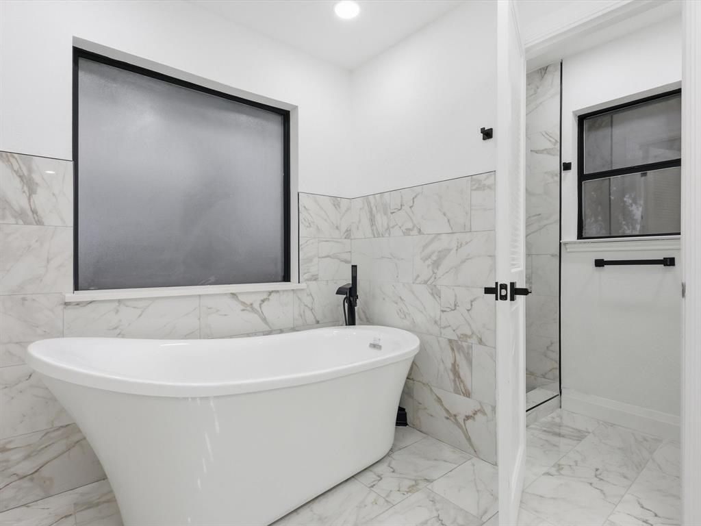 1202 High Ridge Drive Duncanville, TX 75137 - Photo 23 of 28 a bathroom with a bathtub and shower