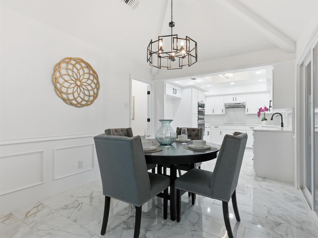 1202 High Ridge Drive Duncanville, TX 75137 - Photo 9 of 28 a view of a dining room with furniture wooden floor and a chandelier