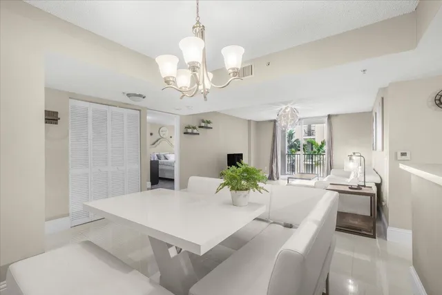 a dining room with furniture and a chandelier