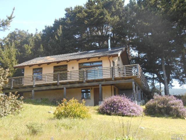 43712 Crispin Road Manchester, CA 95459 - Photo 1 of 1 a front view of house with yard and trees in the background