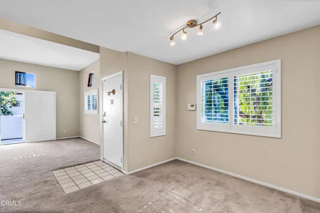 an empty room with windows and closet