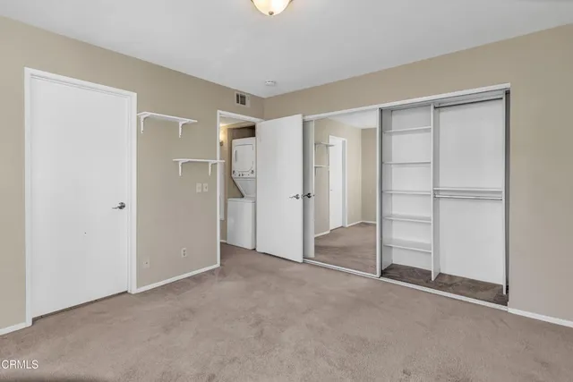 a view of an empty room with closet area