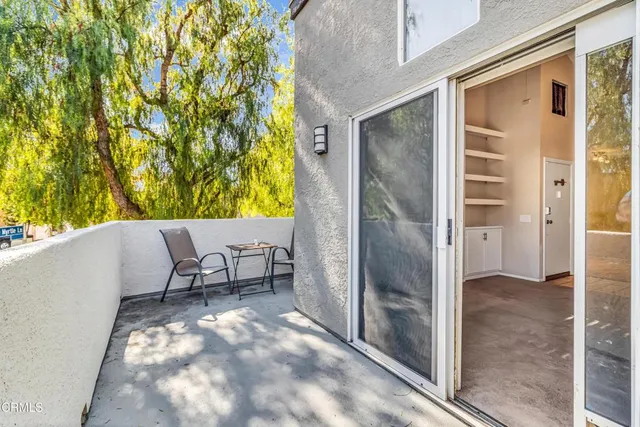 a view of a balcony with table and chairs