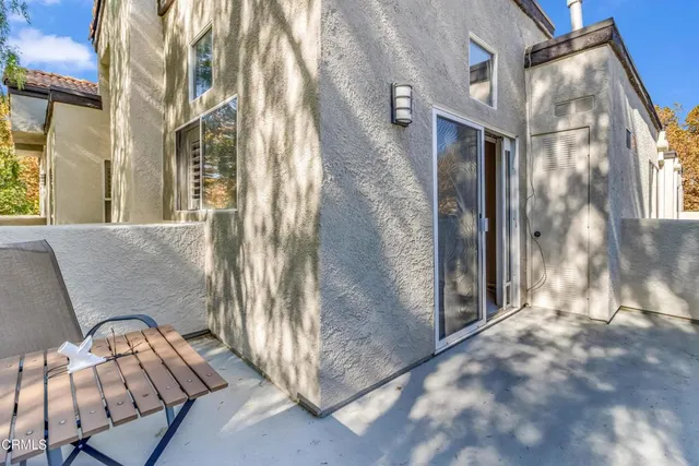 a backyard of a house with table and chairs
