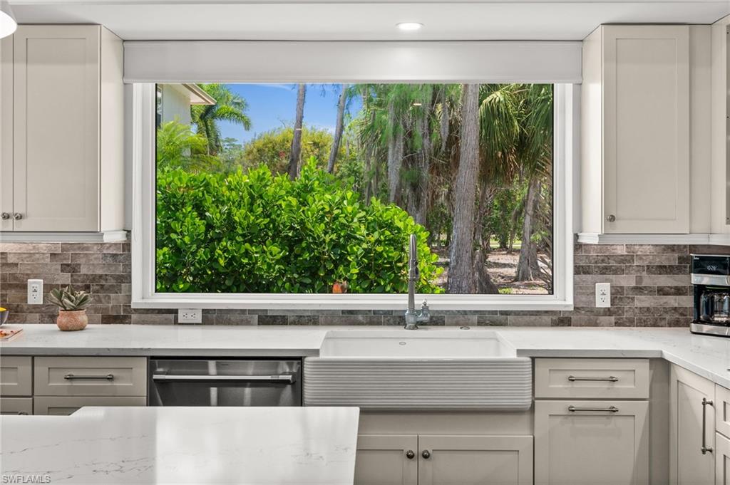 2003 Duke Drive Naples, FL 34110 - Photo 12 of 45 Kitchen sink area with expansive window overlooking beautifully landscaped grounds