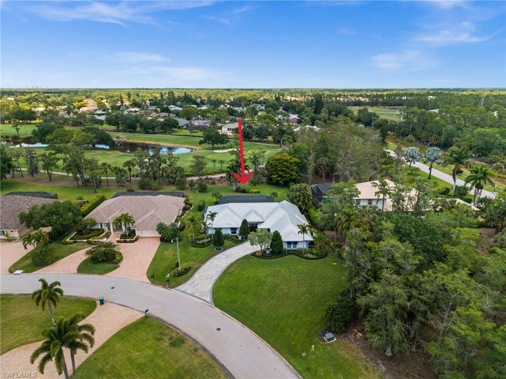 2003 Duke Drive Naples, FL 34110 - Photo 37 of 45 Aerial view showcasing the expansive, beautifully landscaped lot and long winding paver driveway.