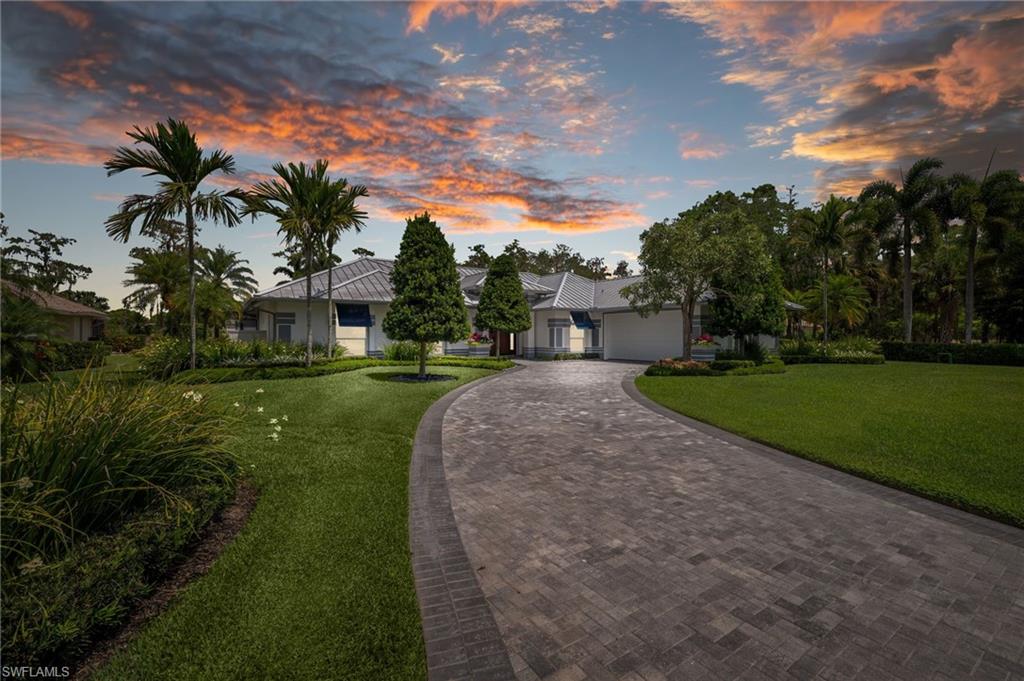 2003 Duke Drive Naples, FL 34110 - Photo 42 of 45 a view of a garden with a building in the background