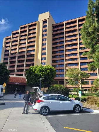 a front view of a building with parking space
