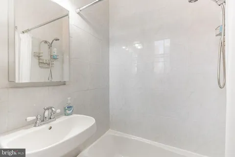 a bathroom with a bathtub and a sink