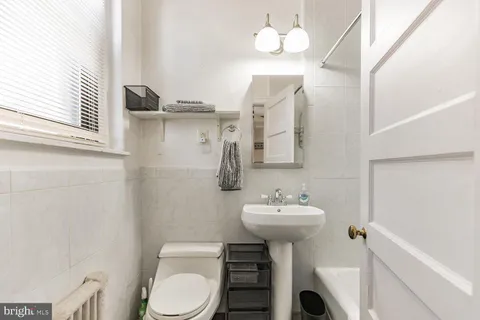 a bathroom with a sink mirror toilet and vanity