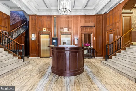 a view of a dining room with floor to ceiling windows and wooden floor