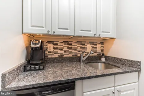 a kitchen with sink and cabinets