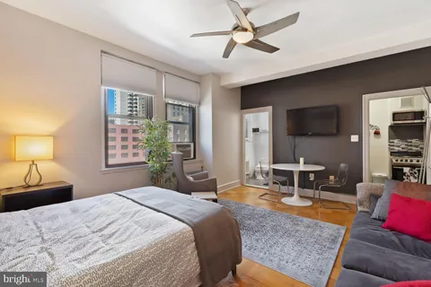 a bedroom with a bed a window and couch