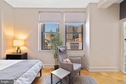 a bedroom with a bed and window