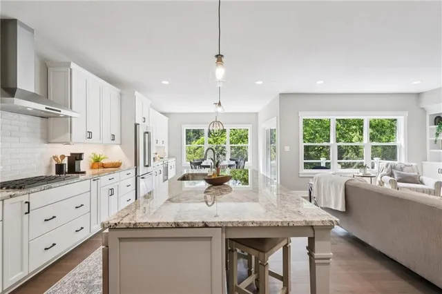 a kitchen with granite countertop a sink and stove