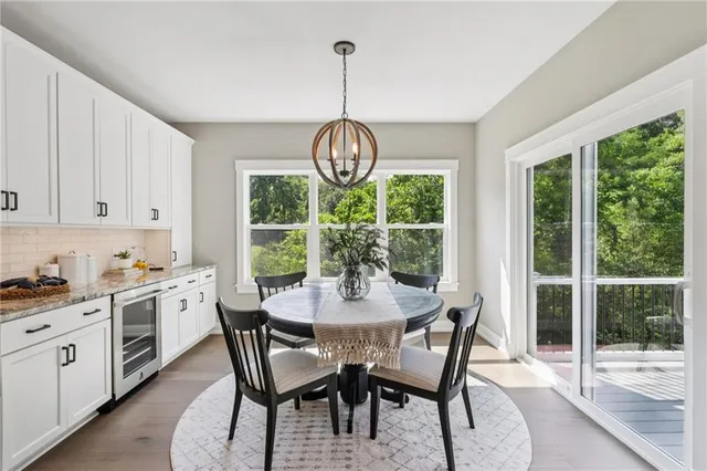 a dining room with furniture a chandelier and wooden floor