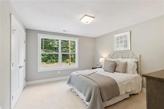 a bedroom with a large bed and a window