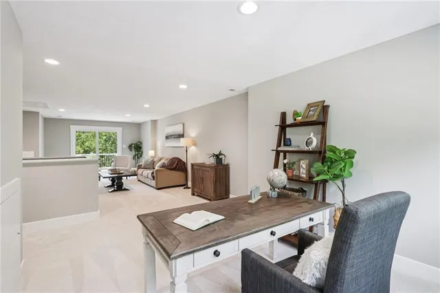 a living room with furniture and large windows