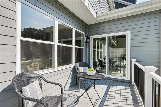 a view of a chairs and fire pit in the balcony