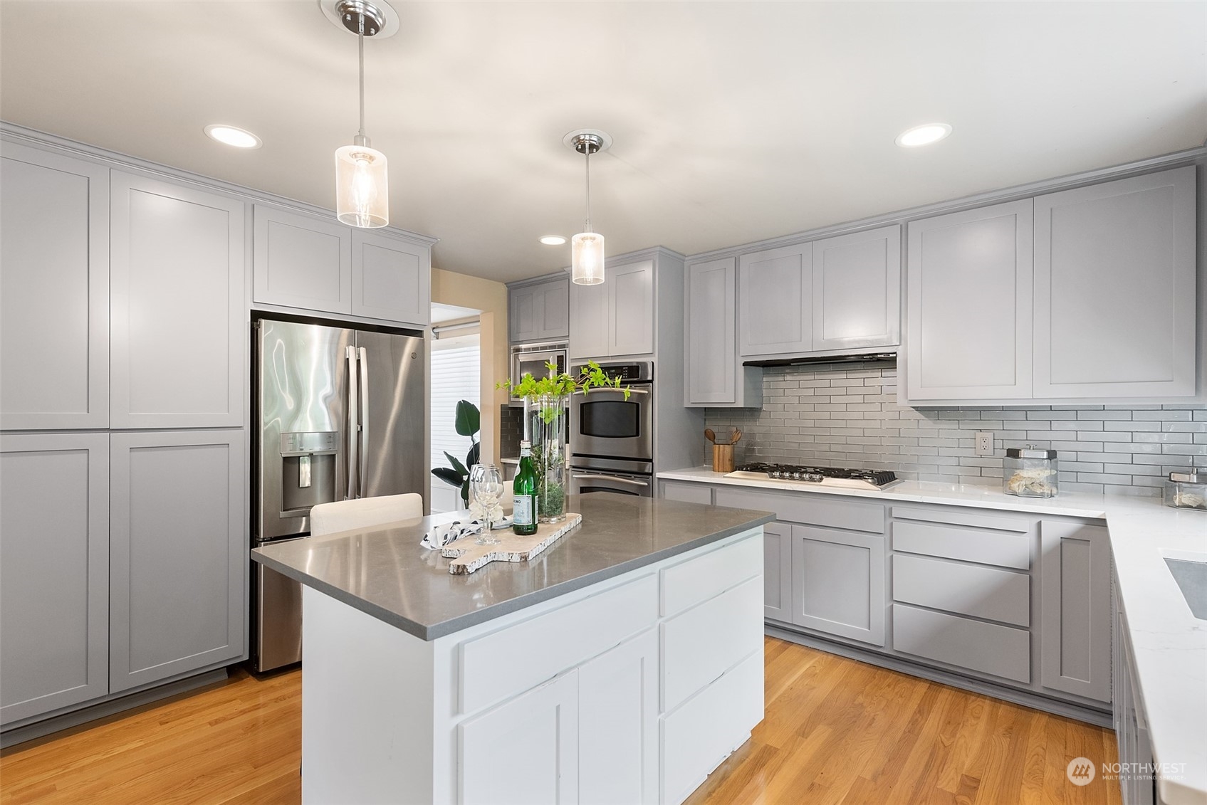 4411 240 Place Southeast Bothell, WA 98021 - Photo 15 of 36 a kitchen with kitchen island granite countertop a sink cabinets and refrigerator