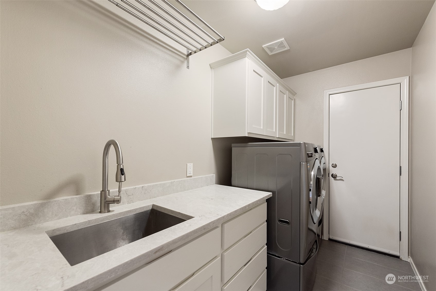4411 240 Place Southeast Bothell, WA 98021 - Photo 18 of 36 a kitchen with a refrigerator and a sink