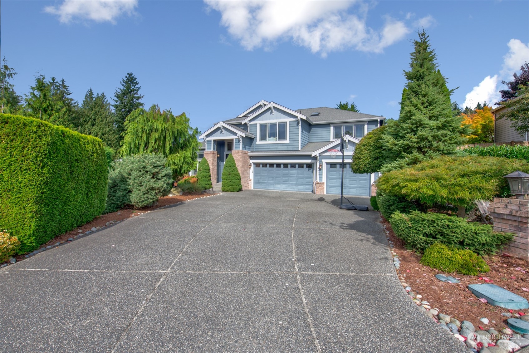 4411 240 Place Southeast Bothell, WA 98021 - Photo 2 of 36 a front view of a house with a garden