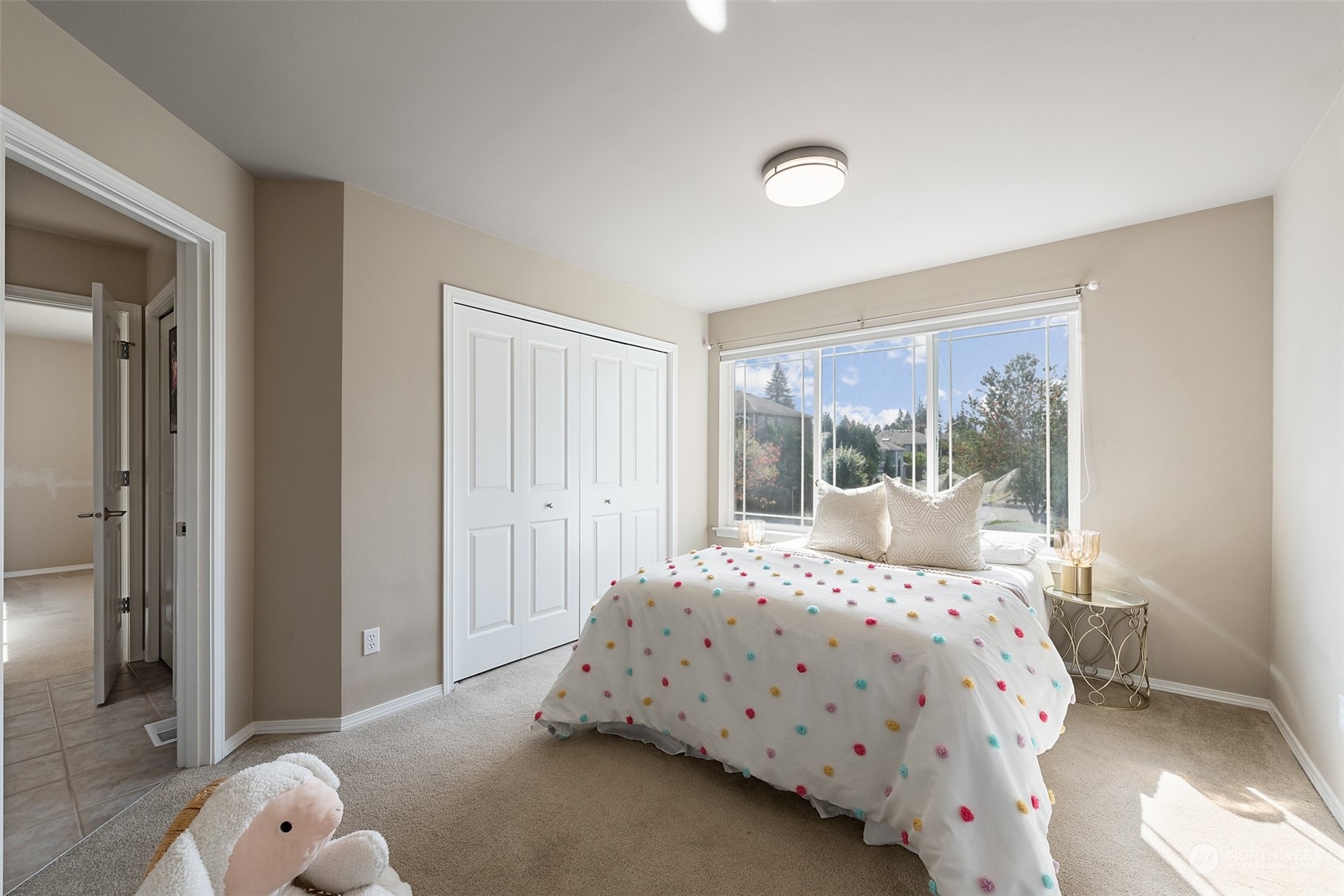 4411 240 Place Southeast Bothell, WA 98021 - Photo 26 of 36 a bedroom with a bed and large window with balcony view