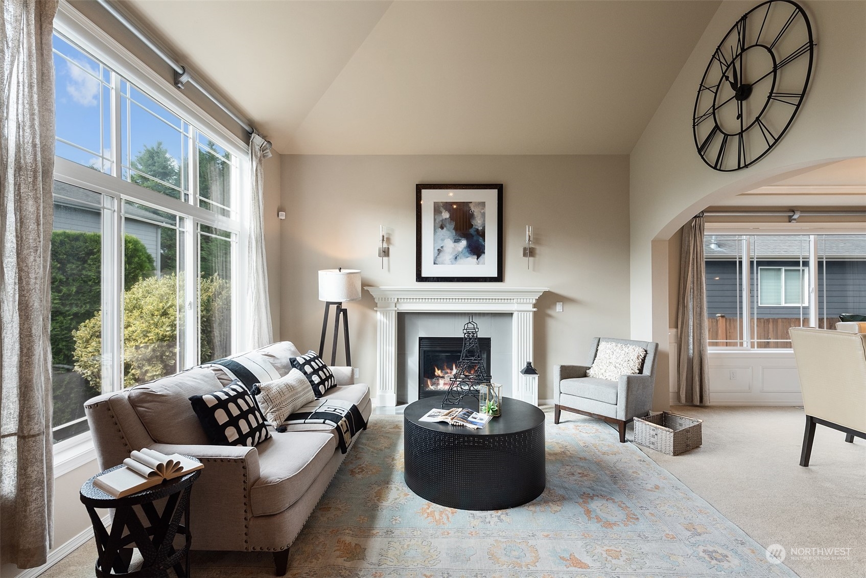 4411 240 Place Southeast Bothell, WA 98021 - Photo 5 of 36 a living room with furniture a fireplace and a large window