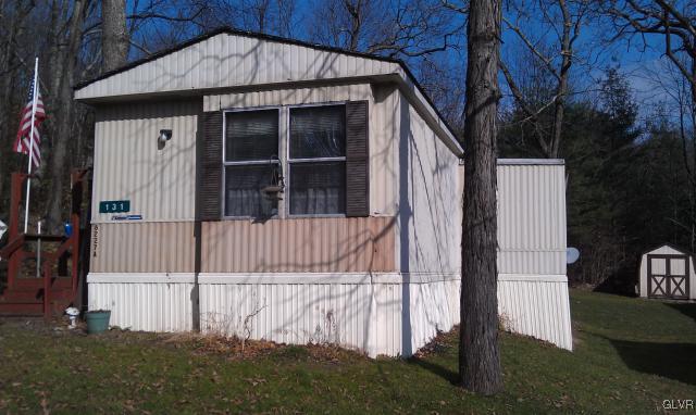 a view of a house with a small yard and wooden fence