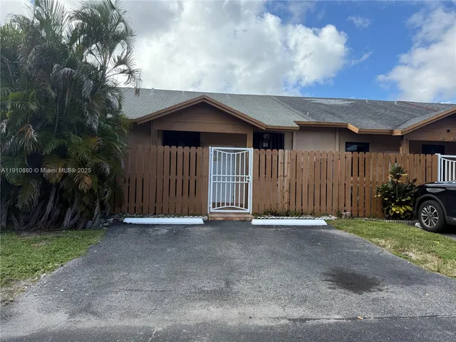 a view of a house with a yard and garage