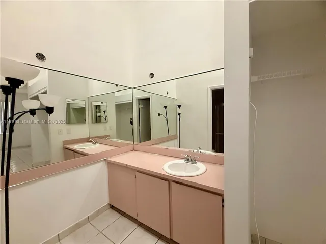 a bathroom with a sink and mirror