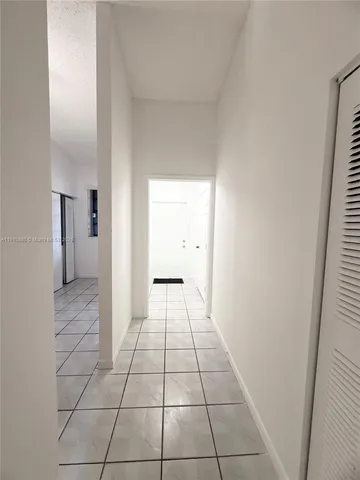 a view of an empty room and a bathroom