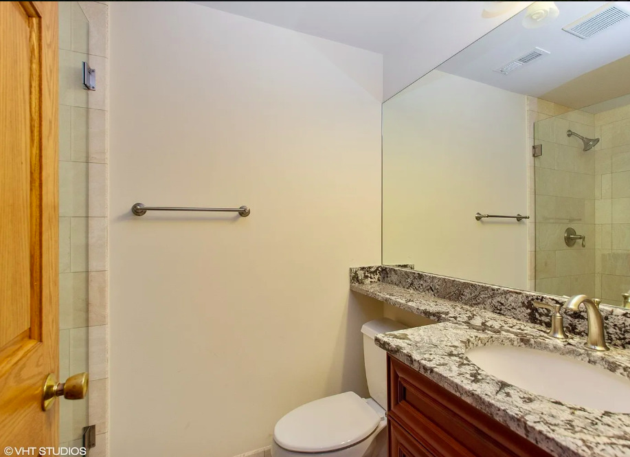 1551 Edgewood Road Lake Forest, IL 60045 - Photo 12 of 16 a bathroom with a granite countertop sink toilet and shower