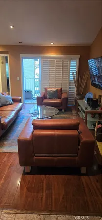 a living room with furniture a rug and a window