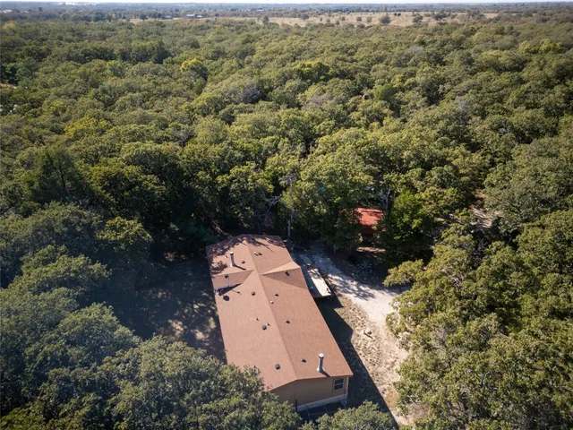an aerial view of a house with a yard