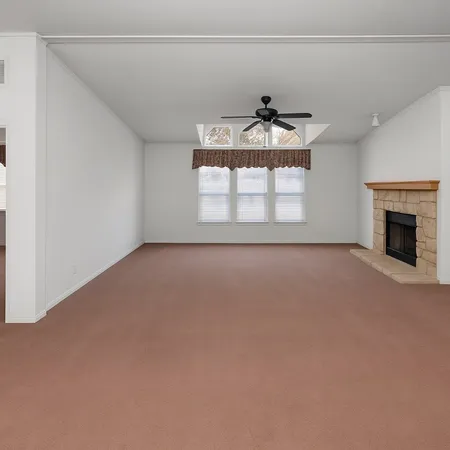 a view of a livingroom with a fireplace and window