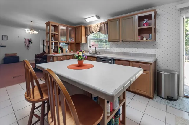a kitchen with a table chairs and a refrigerator