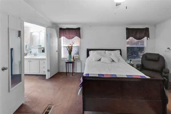a bedroom with a bed and a chair