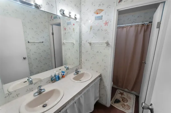 a bathroom with a sink double vanity and a mirror