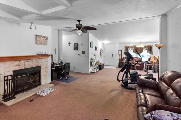 a view of a livingroom with furniture and a ceiling fan