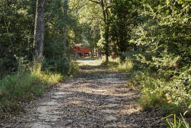 a backyard of a house with a yard and outdoor seating