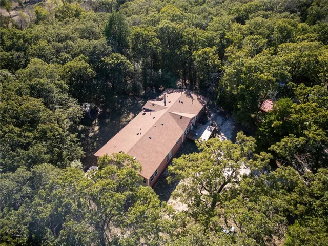 an aerial view of a house with a yard and garden